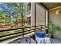 A cozy balcony with outdoor seating and a view of a landscaped yard at 415 Ocean Creek Dr. # 2145, Myrtle Beach, SC 29572