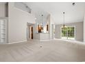 Spacious living room with vaulted ceilings, carpet, and a view to the kitchen at 4165 Eva Bay Dr., Murrells Inlet, SC 29576