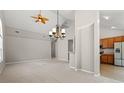 Open floor plan showcasing the living room with ceiling fan and the adjacent kitchen at 4165 Eva Bay Dr., Murrells Inlet, SC 29576