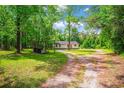 Quaint home nestled in a lush wooded area, featuring a covered storage area and a spacious driveway at 4391 Party Pines Rd., Conway, SC 29526