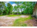 Expansive front yard with ample parking space, surrounded by mature trees and lush greenery at 4391 Party Pines Rd., Conway, SC 29526