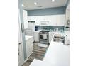 Charming kitchen with white cabinets, stainless steel appliances, and modern countertops at 4449 Turtle Ln. # 3A, Little River, SC 29566