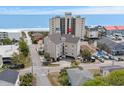 Aerial view of a condo in close proximity to the beach, with other houses and a tall condo in the background at 4500 S Ocean Blvd. # 4, North Myrtle Beach, SC 29582