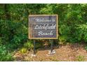 A welcoming sign to Litchfield Beach surrounded by lush greenery and foliage at 56 Henderson Way, Pawleys Island, SC 29585