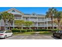 Attractive three-story condo featuring classic architecture, private balconies, and lush landscaping at 5751 Oyster Catcher Dr. # 431, North Myrtle Beach, SC 29582