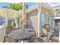 Outdoor deck features an umbrella-shaded table with seating for enjoying sunny days at 6001-1592 South Kings Hwy., Myrtle Beach, SC 29575