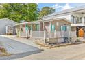 Inviting home with a covered porch and white railing, ideal for relaxing outdoors at 6001-1592 South Kings Hwy., Myrtle Beach, SC 29575