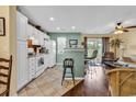 Bright kitchen with white appliances and tiled flooring open to the living area at 604 Wilshire Ln. # 604, Murrells Inlet, SC 29576