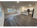 Bright living area seamlessly blends hardwood floors with plush carpet, leading to a modern kitchen at 624 Muster Field Ct., Conway, SC 29526