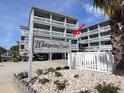 Beautiful condominium exterior featuring multiple balconies and a 'Whispering Sands' sign surrounded by well-maintained landscaping at 627 N Waccamaw Dr. # 203, Murrells Inlet, SC 29576