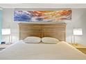 Bedroom showcases a comfy bed with a decorative ocean-themed art piece above the headboard at 7200 Ocean Blvd. N # 664, Myrtle Beach, SC 29572