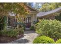 Charming entrance with stone pathway, manicured bushes, and a striking wood door at 741 Tuckers Rd., Pawleys Island, SC 29585