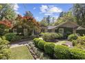 Inviting brick home with stone pathway and lush greenery leading to the front entrance at 741 Tuckers Rd., Pawleys Island, SC 29585