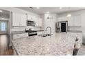 Modern kitchen with granite countertops, stainless steel appliances, and ample cabinet space at 1087 Baker Creek Loop, Myrtle Beach, SC 29579