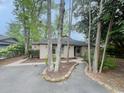 Home exterior showcasing beautiful landscaping, a paved driveway, and mature trees at 116 Hickory Dr., Conway, SC 29526