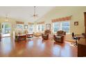 Spacious living room with vaulted ceiling, hardwood flooring and lots of natural light from surrounding windows at 1250 Camlet Ln., Little River, SC 29566
