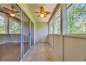 Relaxing screened porch with tiled flooring and a ceiling fan, perfect for enjoying the outdoors at 1260 White Tree Ln. # F, Myrtle Beach, SC 29588
