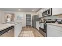 Modern kitchen showcasing stainless steel appliances, granite countertops, and an island with seating at 152 Ashworth Dr., Tabor City, NC 28463