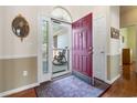 Inviting entryway with a red front door, hardwood floors, and neutral wall tones at 162 Jessica Lakes Dr., Conway, SC 29526