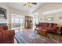 Cozy living room with hardwood floors, vaulted ceiling, and views into adjacent sunroom at 162 Jessica Lakes Dr., Conway, SC 29526