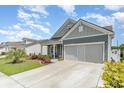 Charming single-story home with well-manicured lawn and a driveway leading to an attached two-car garage at 1827 Parish Way, Myrtle Beach, SC 29577