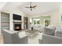 Bright living room with a fireplace, modern furniture, high ceilings, and large windows that offer scenic views at 1827 Parish Way, Myrtle Beach, SC 29577