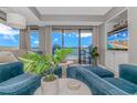 Cozy living room boasts comfortable blue chairs, a beach view, and sliding glass doors to a balcony at 200 72Nd Ave. N # 501, Myrtle Beach, SC 29572