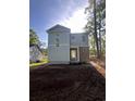 New construction featuring stone accents and a modern design, surrounded by a wooded lot at 2212 Dykman Circle, Little River, SC 29566