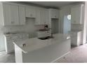 Bright kitchen featuring white cabinets, a spacious island, and stainless steel faucet at 2212 Dykman Circle, Little River, SC 29566
