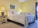 Cozy bedroom with a queen bed, two nightstands, and a sliding door to the balcony at 223 Maison Dr. # D-16, Myrtle Beach, SC 29572