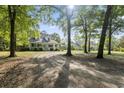 Exterior view of a beautiful home with mature trees and a long driveway at 228 Hopeland St., Pawleys Island, SC 29585