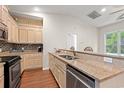 Well-lit kitchen featuring wood cabinets, granite counters, and stainless steel appliances at 265 South Causeway Rd., Pawleys Island, SC 29585