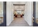Inviting entryway featuring open doors, hardwood floors, soaring ceilings, and a glimpse into the stylish living room at 28 William Screven Ln., Georgetown, SC 29440
