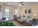 Comfortable living room filled with natural light, a ceiling fan, modern furniture, and an area rug at 2800 Cook Circle # C, Myrtle Beach, SC 29577