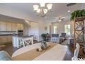 Open living space with a dining area, kitchen, and modern furnishings including a ceiling fan at 2800 Cook Circle # C, Myrtle Beach, SC 29577