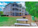 Condo backyard with picnic table, grill, and lawn space at 290 Woodlands Way Nw # 10, Calabash, SC 28467