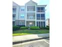 Attractive condo building featuring screened in porches, a nice lawn and professional landscaping at 290 Woodlands Way Nw # 10, Calabash, SC 28467