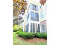 Charming condo building with brick accents, screened in porches, and beautifully landscaped grounds at 290 Woodlands Way Nw # 10, Calabash, SC 28467