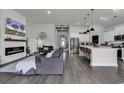 Open-concept living room with a fireplace, kitchen island, and hardwood floors at 305 Calhoun Falls Dr., Myrtle Beach, SC 29579
