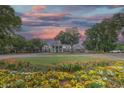 Stunning clubhouse featuring colonial architecture, surrounded by colorful flower beds and picturesque landscaping at 307 Golden Bear Dr. # 3, Pawleys Island, SC 29585