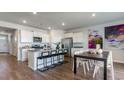 Open-concept kitchen with a large island, stainless steel appliances, white cabinets, and adjacent dining area at 311 Glade Ct., Loris, SC 29569