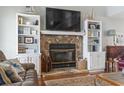 Close up of a cozy stone fireplace with built-in bookshelves and nautical decor accents at 312 47Th Ave. N, North Myrtle Beach, SC 29582