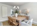 Inviting dining room with natural wood table, stylish chandelier, and decor accents at 316 Glacier Way, Conway, SC 29526