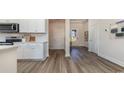 Bright kitchen featuring white cabinets, stainless steel appliances, and wood-look flooring at 334 Glacier Way, Conway, SC 29526