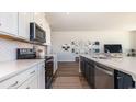 Well-appointed kitchen with quartz counters, white and navy cabinets, and stainless steel appliances at 334 Glacier Way, Conway, SC 29526