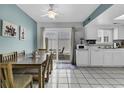 Open-concept kitchen with white cabinets, dining area, and sliding glass doors to the patio at 405 N Hillside Dr. N # C3, North Myrtle Beach, SC 29582