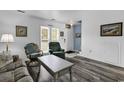 Inviting living room with gray wood floors and lots of natural light at 405 N Hillside Dr. N # C3, North Myrtle Beach, SC 29582