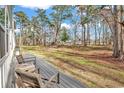 Expansive backyard with a view from the deck, showcasing the natural beauty of the surrounding trees and landscape at 4698 Cloisters Ln., Myrtle Beach, SC 29577