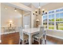 Bright dining room featuring a white table set, chandelier, and large windows at 509 Fallen Leaf Ct., Myrtle Beach, SC 29588