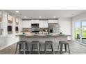 Stylish kitchen with white cabinets, a breakfast bar, and stainless appliances at 5153 Yellowstone Dr., Conway, SC 29526